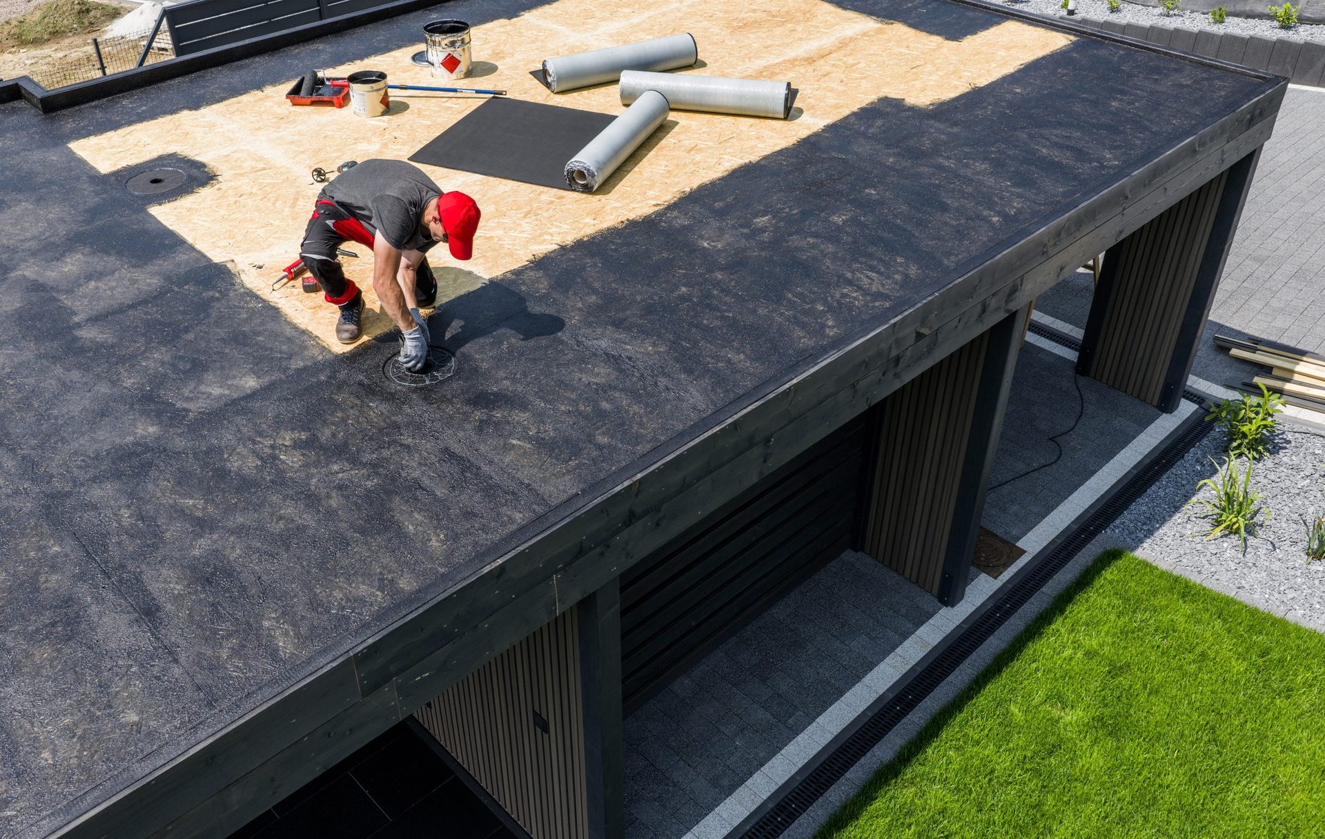 Roofer installing a new flat roof Roofer installing a new flat roof covering