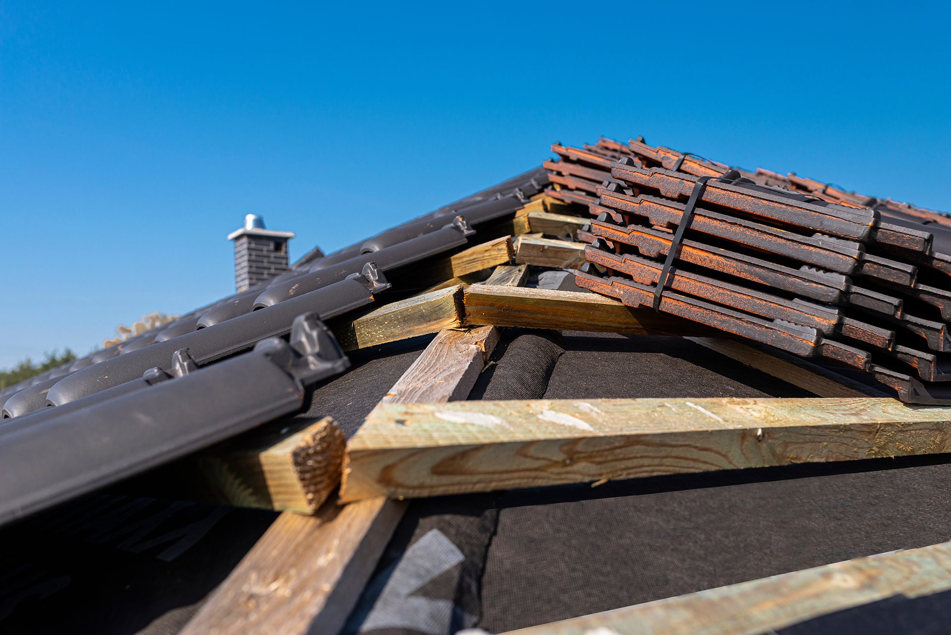 New roofing tiles to go on roof in Devon New roof tiles stacked ready for installation