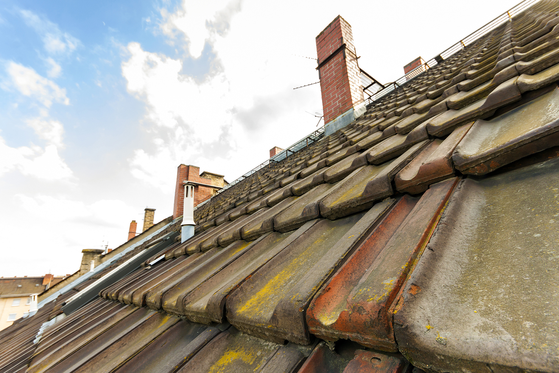Old tiled roof with chimney stacks
